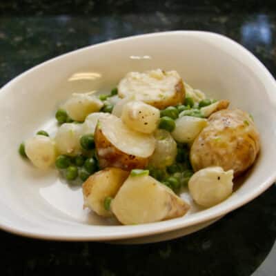 Creamed new potatoes with peas and onions.