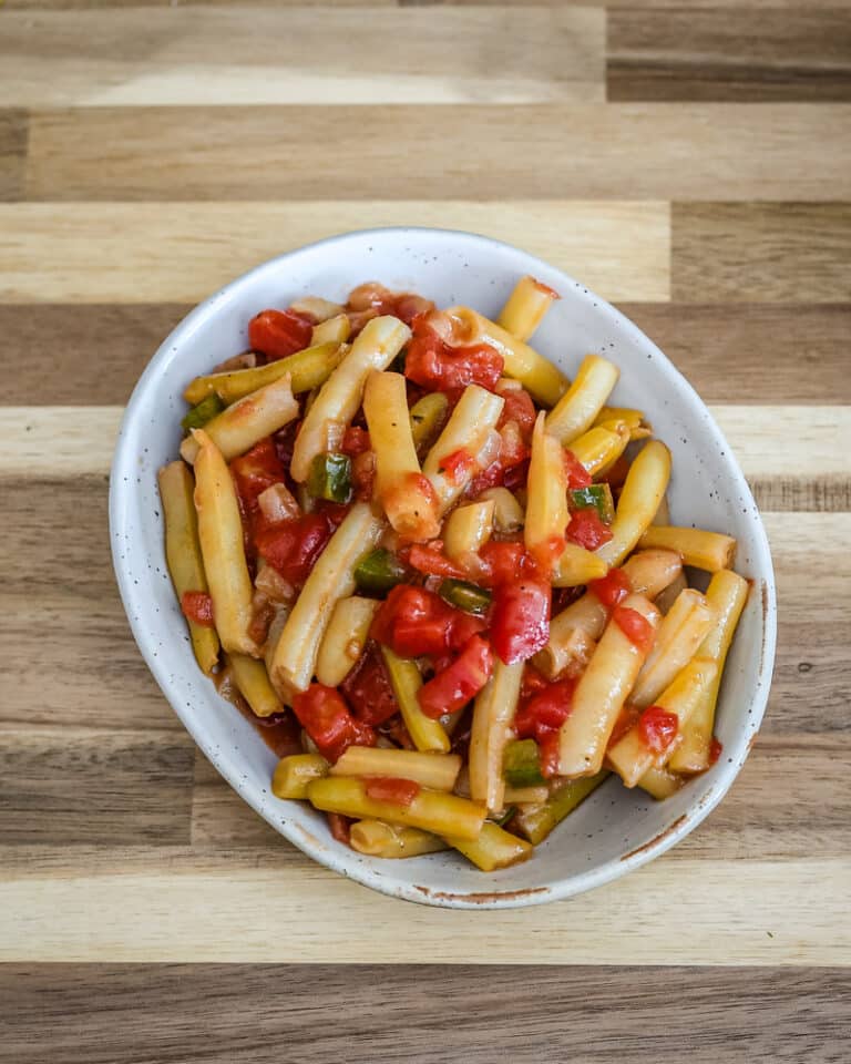 Creole-style wax beans with tomatoes in a a small dish.