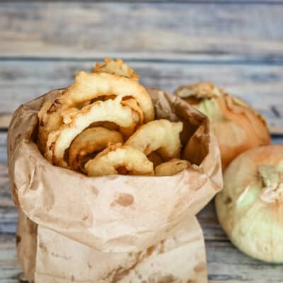 Onion rings in a paper bag.