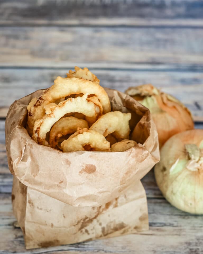 Onion rings in a paper bag.