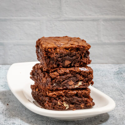 Fudgy Brownies stacked on a small plate.