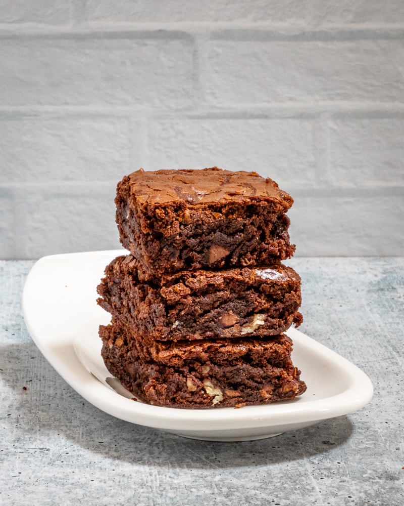 Fudgy Brownies stacked on a small plate.