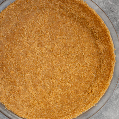 A graham cracker pie crust in a pie plate.