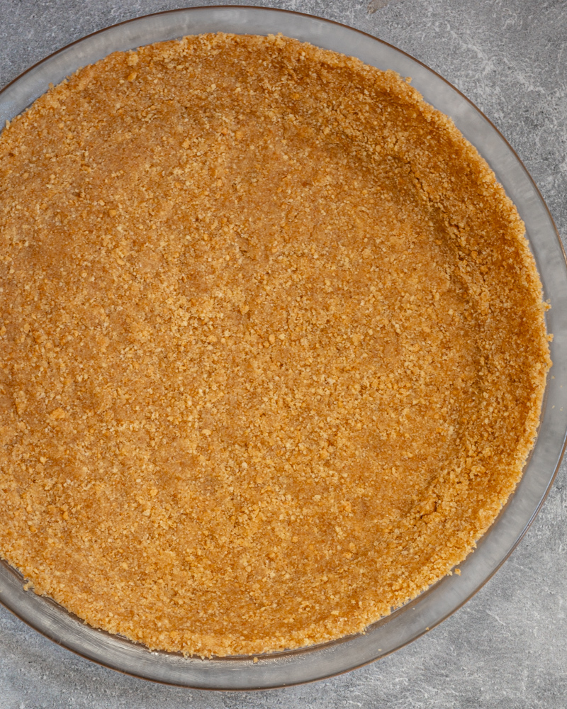 A graham cracker pie crust in a pie plate.