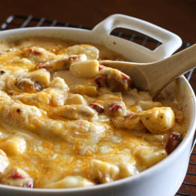 A baking dish with cheesy hot dot and potato casserole.