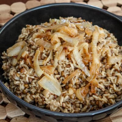 A dish of mujadara with lentils, rice, and onions.