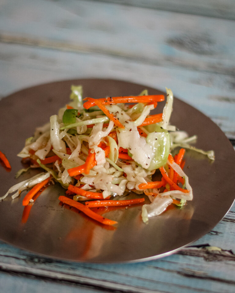 A serving of north carolina coleslaw on a small plate.