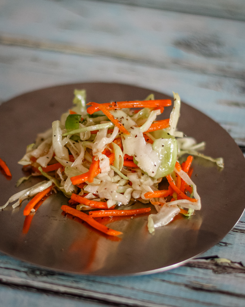 A serving of north carolina coleslaw on a small plate.