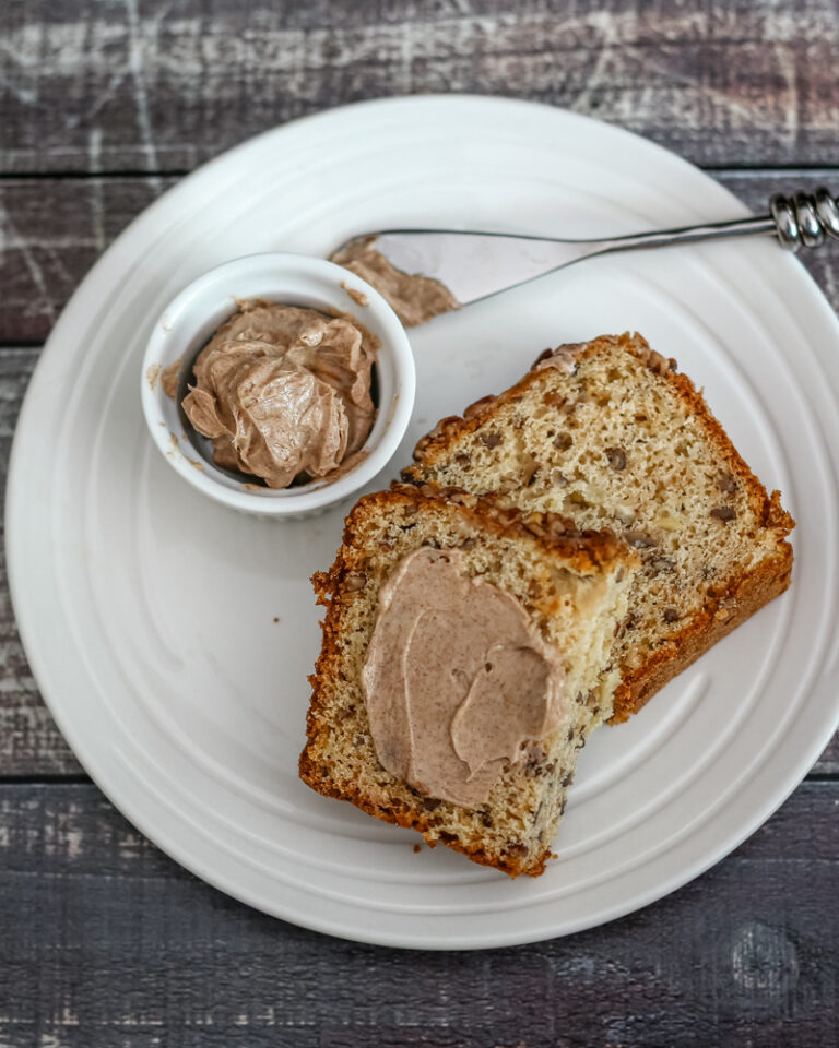 Slices of banana bread with cinnamon butter on the side.