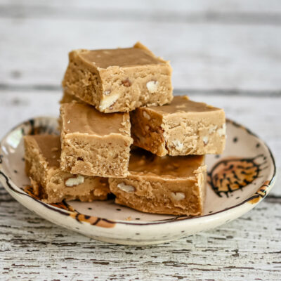 Peanut butter fudge is stacked on a small plate