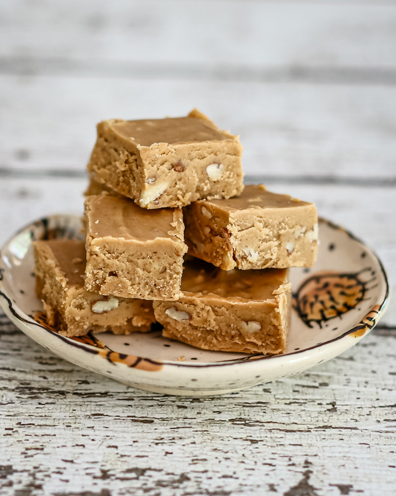 Peanut butter fudge is stacked on a small plate