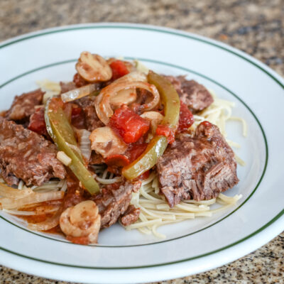 Pepper steak strips with tomatoes, onions, and bell peppers.