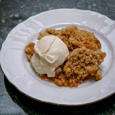 Rhubarb crisp and ice cream on a plate.