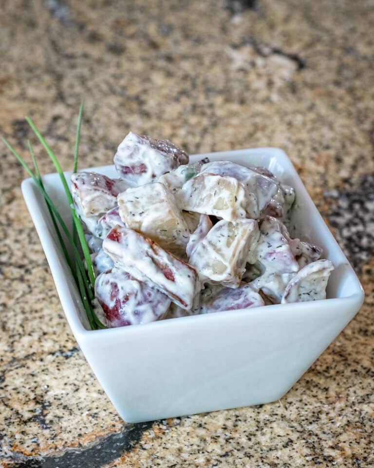 A small dish of roasted potato salad.