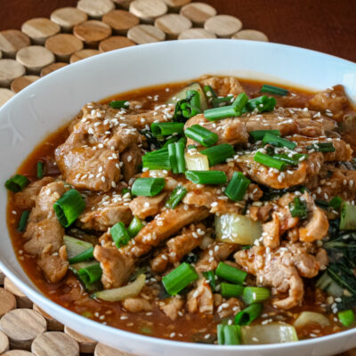 A serving bowl with sesame pork.