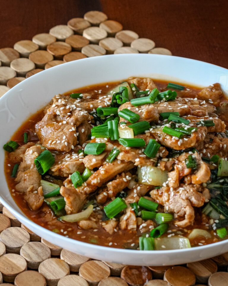 A serving bowl with sesame pork.