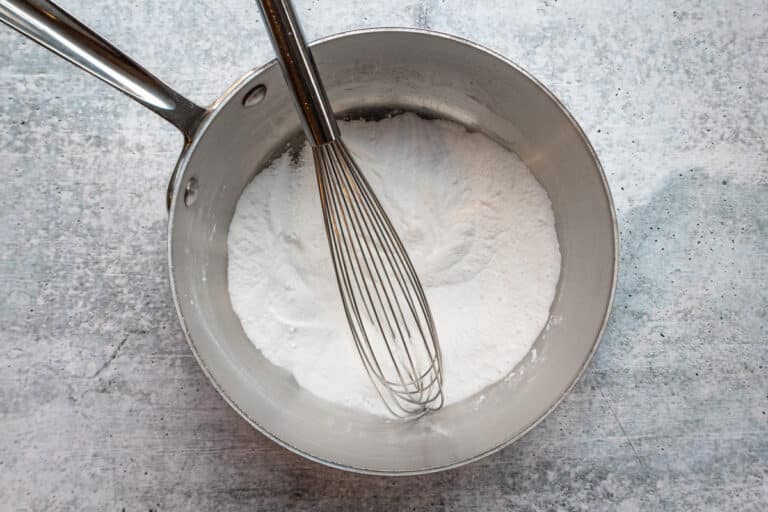 Making lemon sauce with sugar and cornstarch.