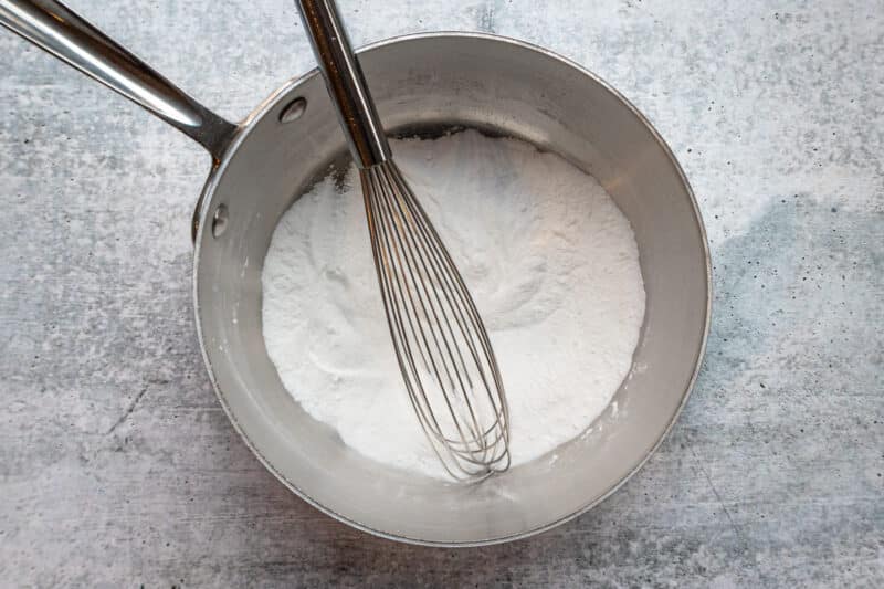 Making lemon sauce with sugar and cornstarch.