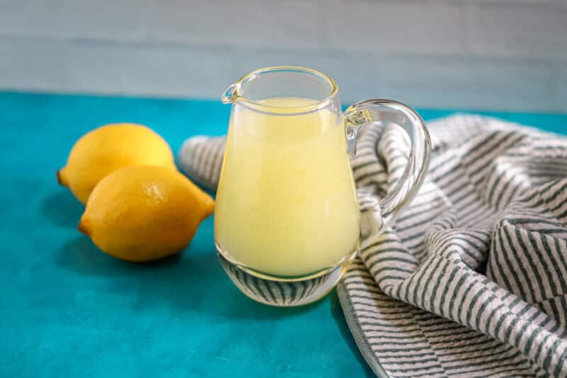 Lemon dessert sauce in a small pitcher.