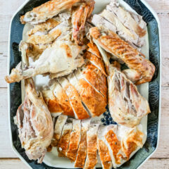 A carved spatchcocked turkey on a large platter.