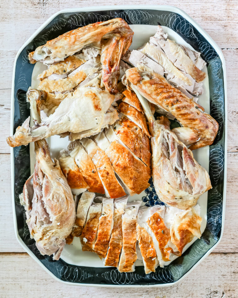 A carved spatchcocked turkey on a large platter.