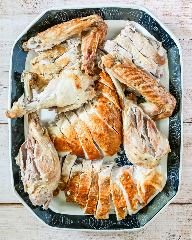 A carved spatchcocked turkey on a large platter.