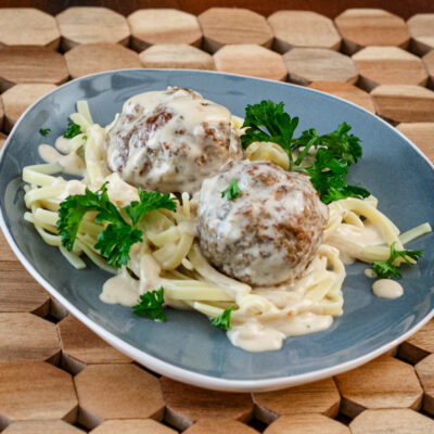 Swedish meatballs on a plate with noodles.