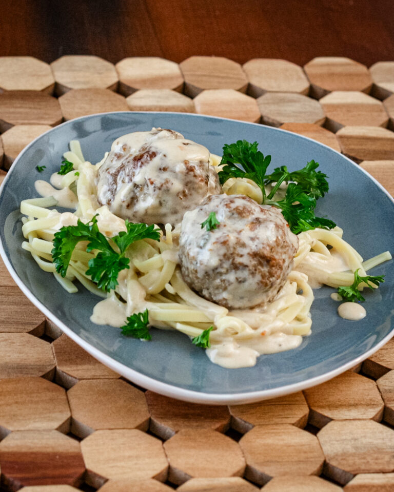Swedish meatballs on a plate with noodles.