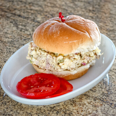 Turkey and egg salad sandwich on a soft bun