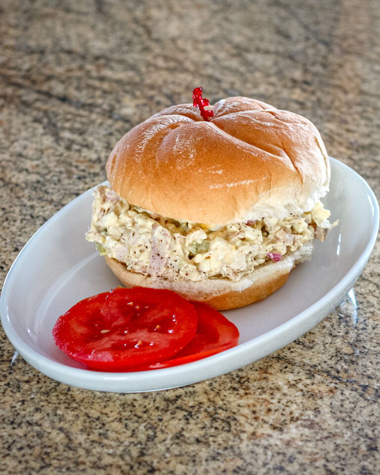 Turkey and egg salad sandwich on a soft bun