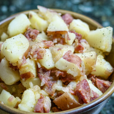 warm potato salad with sausage in a bowl