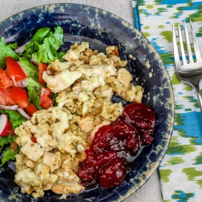 Chicken and dressing casserole with some cranberry sauce and a small salad.