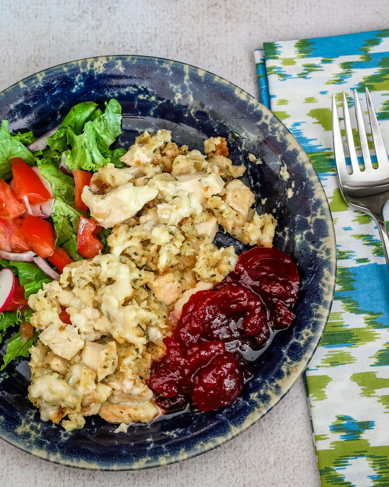 Chicken and dressing casserole with some cranberry sauce and a small salad.