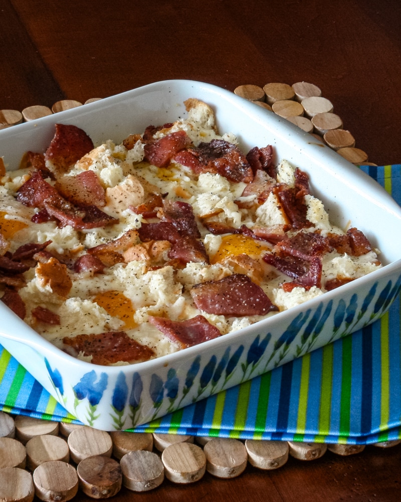 A baking dish with a bacon and egg casserole.