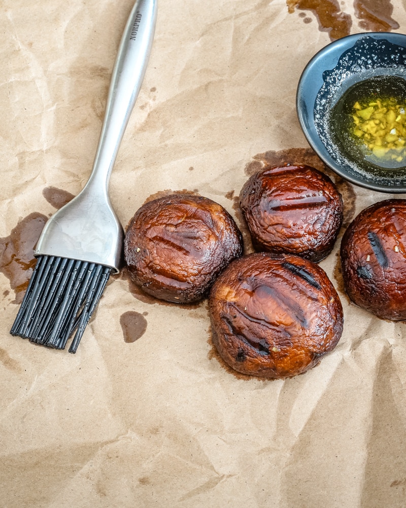 Grilled mushrooms with melted butter and brush.