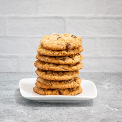 A stack of oatmeal chocolate chip cookies on a plate.