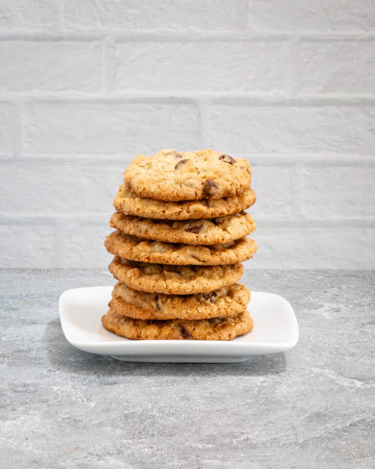 A stack of oatmeal chocolate chip cookies on a plate.
