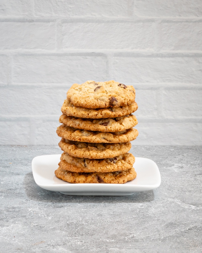 A stack of oatmeal chocolate chip cookies on a plate.