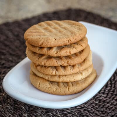 A stack of peanut butter cookies on a small plate.