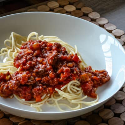 Spaghetti in a bowl with a meaty sauce.