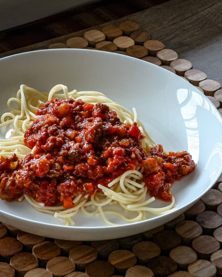 Spaghetti in a bowl with a meaty sauce.