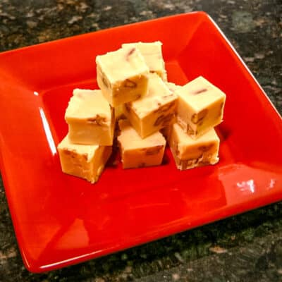 A red plate with sour cream fudge.
