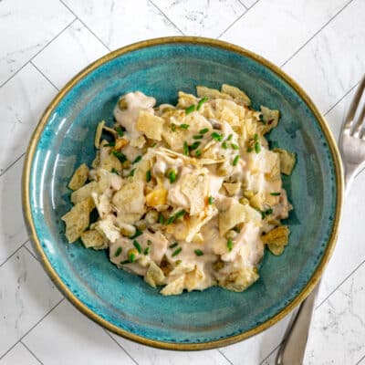 Tuna casserole with potato chip topping and some chives for garnish.