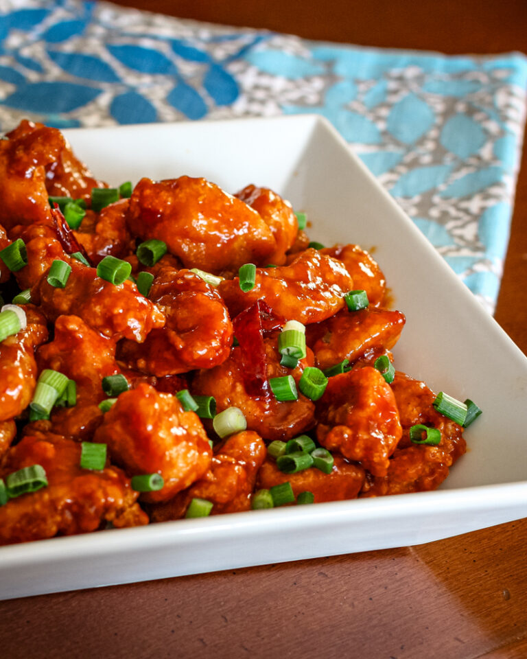 A serving bowl with general tso's chicken.