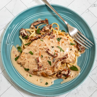 Marry me chicken served on cooked spaghetti with creamy sundried tomato sauce.