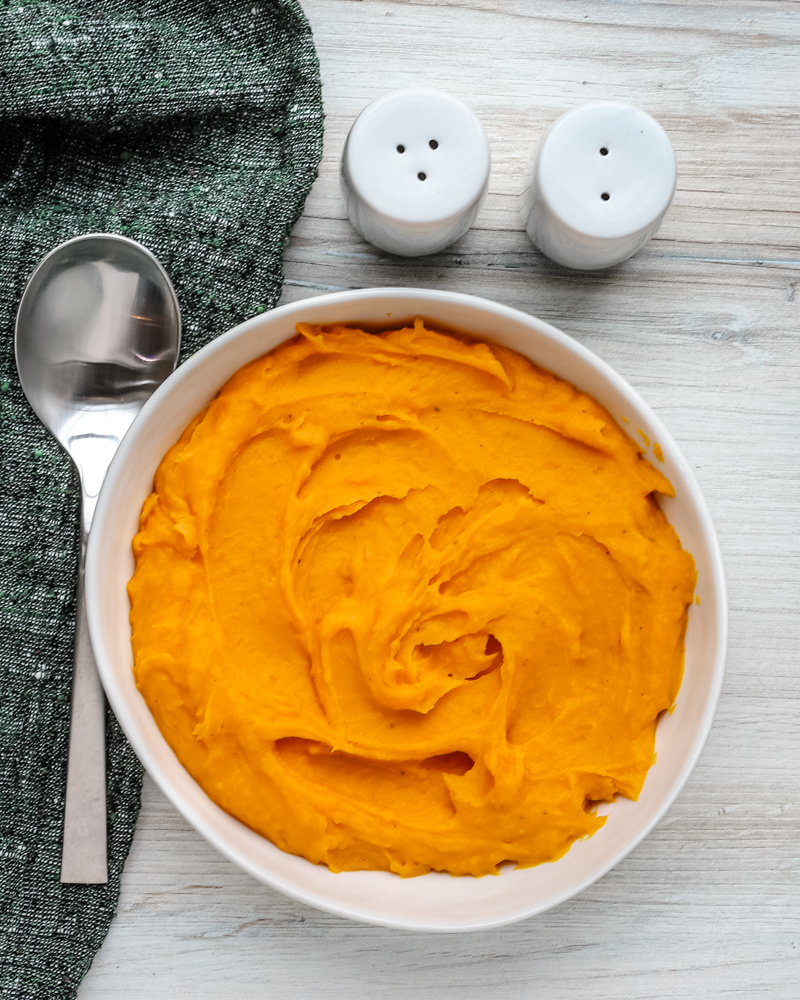 A serving bowl with mashed butternut squash.