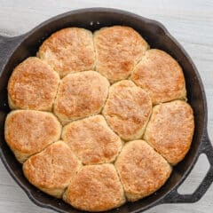 A skillet with fluffy baked angel biscuits.