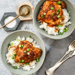 Overhead shot of Instant Pot chicken adobo with scallion garnish and shown on rice.