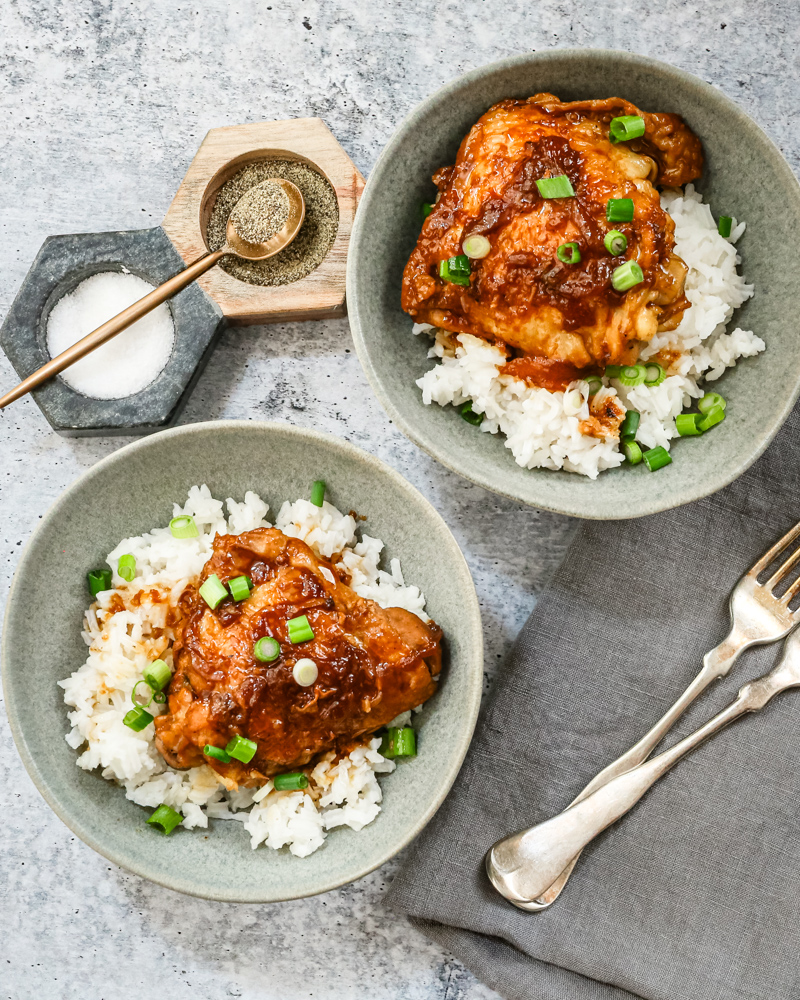 Overhead shot of Instant Pot chicken adobo with scallion garnish and shown on rice.