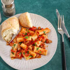 Overhead shot with a bright and flavorful sausage ragu made with Italian sausage, hand-crushed tomatoes, garlic, and onions.